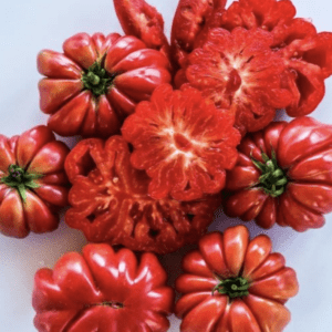 Bright red, uniquely shaped bell peppers with star-like patterns inside.